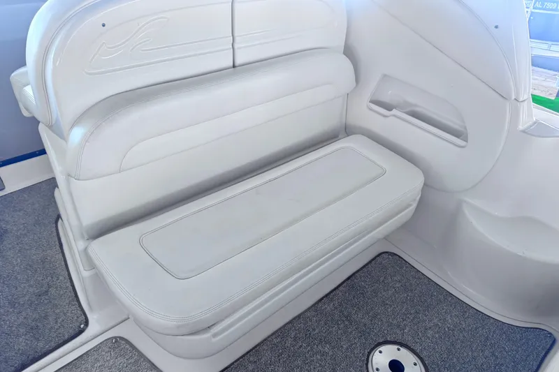 Slide: The Image of 2005 Sea Ray 300 Sundancer interior seating with white upholstery and carpeted flooring. - 7