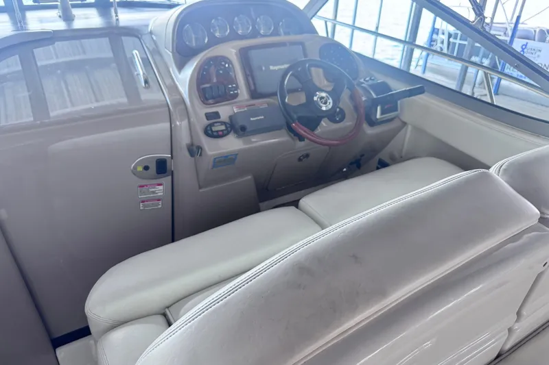 Slide: The Image of 2005 Sea Ray 300 Sundancer helm with steering wheel and control panel. - 9