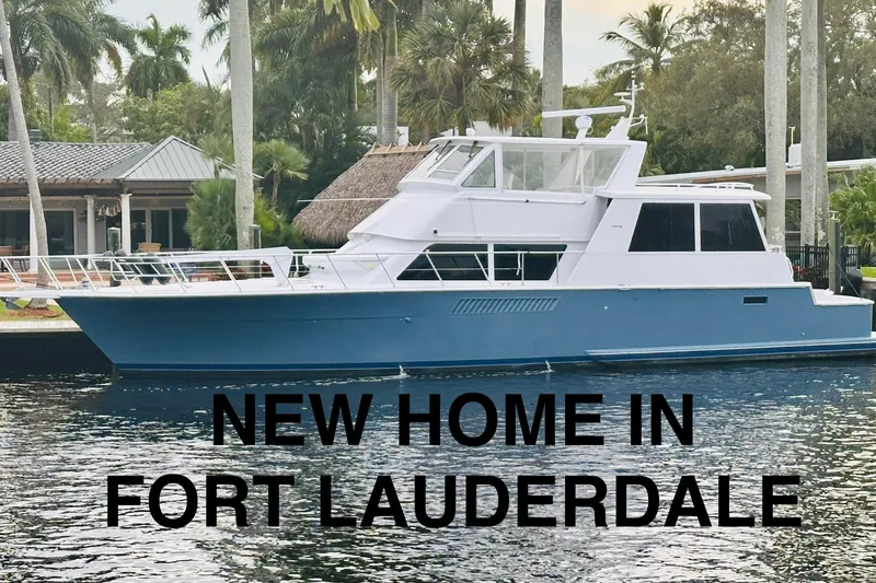 The Image of 1999 Viking Cockpit Sports Yacht docked in Fort Lauderdale, surrounded by palm trees. - 0