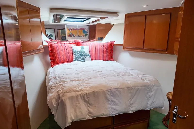 Slide: The Image of Interior of 1999 Viking Cockpit Sports Yacht bedroom with TV and ensuite bathroom. - 11