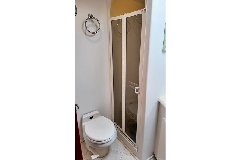 Slide: The Image of Bathroom interior of 1999 Viking Cockpit Sports Yacht with colorful decor and shower. - 15