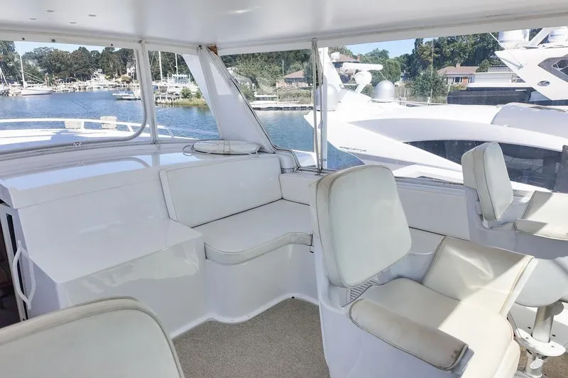 Slide: The Image of Bathroom sink area in a 1999 Viking Cockpit Sports Yacht, featuring a mirror and faucet. - 18