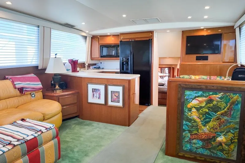 Slide: The Image of 1999 Viking Cockpit Sports Yacht docked in urban marina with palm trees. - 2