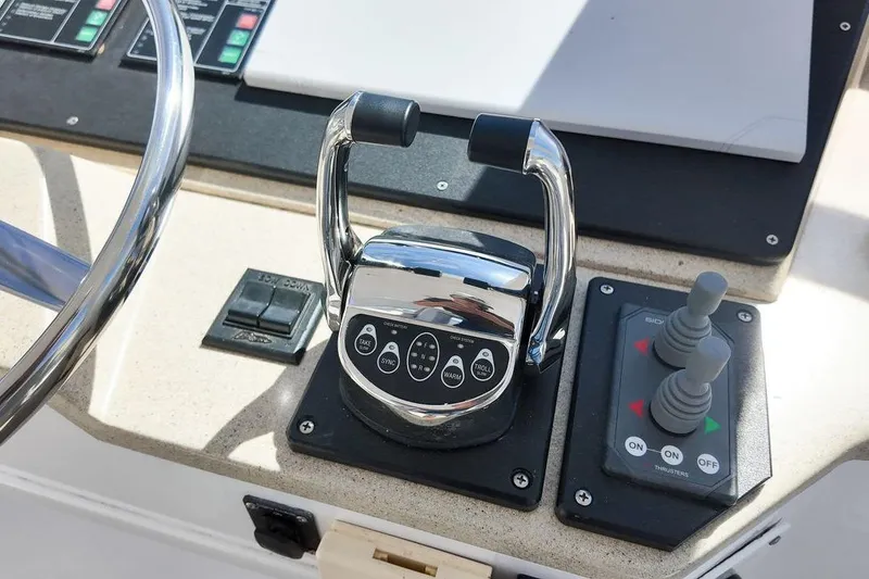 Slide: The Image of 1999 Viking Cockpit Sports Yacht interior with white seating and marina view. - 22