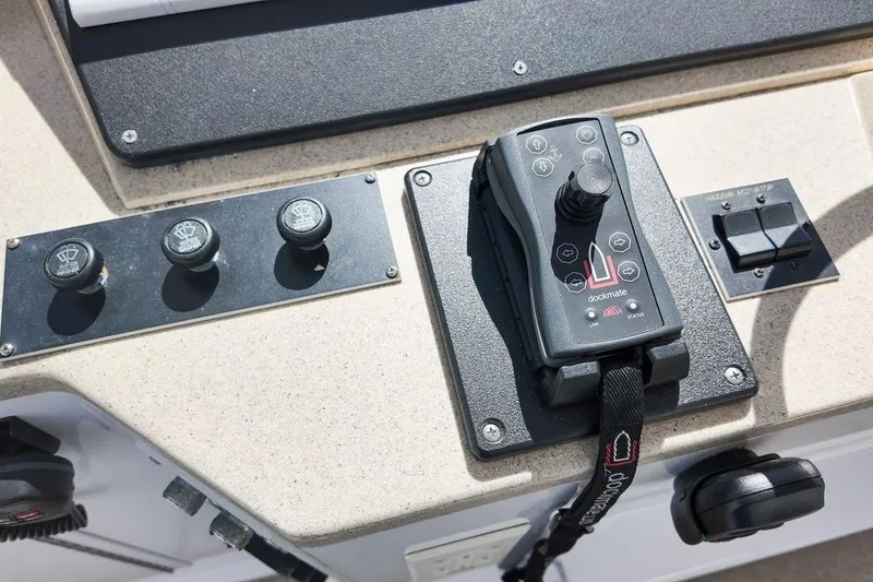 Slide: The Image of 1999 Viking Cockpit Sports Yacht interior with white captain chairs and control panel. - 23