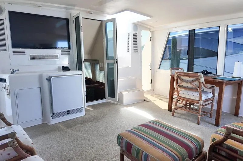 Slide: The Image of 1999 Viking Cockpit Sports Yacht interior with storage cabinets and hose connection. - 31