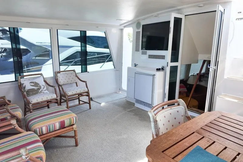 Slide: The Image of 1999 Viking Cockpit Sports Yacht docked, with parked vehicles in the background. - 32