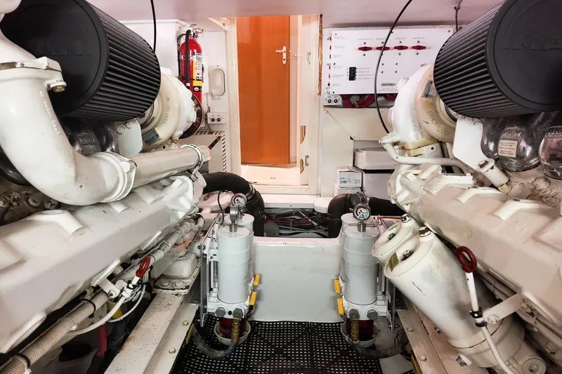 Slide: The Image of 1999 Viking Cockpit Sports Yacht docked, showcasing sleek design and spacious deck. - 33