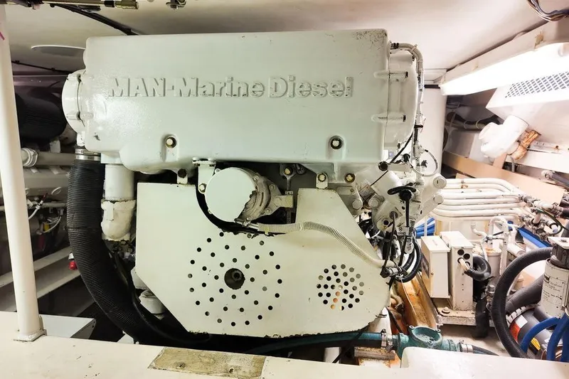 Slide: The Image of 1999 Viking Cockpit Sports Yacht with white deck and seating area by the water. - 35