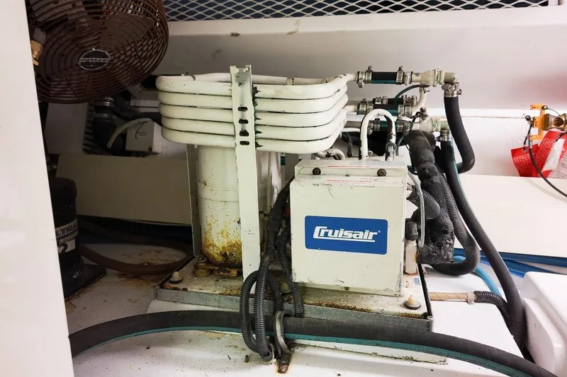 Slide: The Image of Engine room of a 1999 Viking Cockpit Sports Yacht, showcasing dual engines and mechanical components. - 39