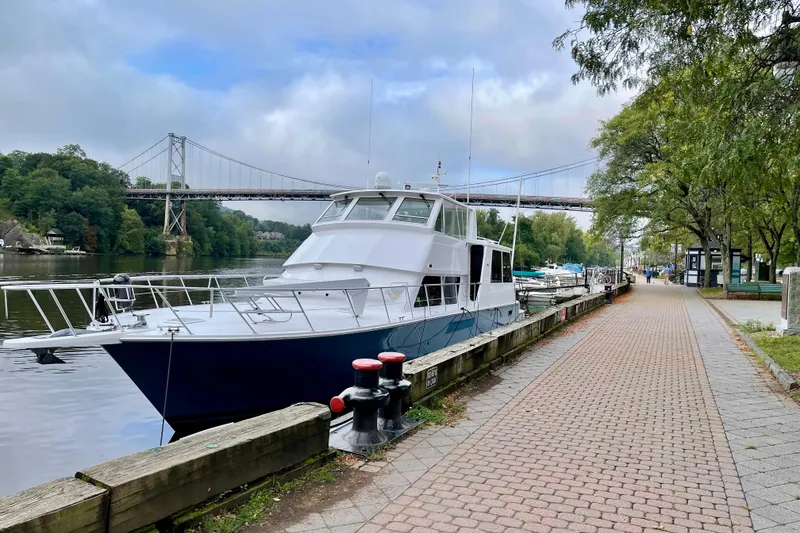 Slide: The Image of 1999 Viking Cockpit Sports Yacht docked at marina under cloudy sky. - 54