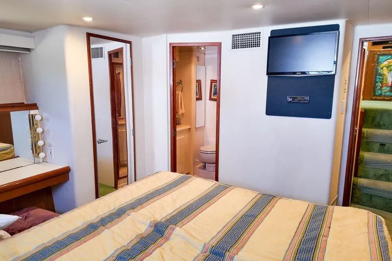 Slide: The Image of 1999 Viking Cockpit Sports Yacht kitchen with built-in dishwasher and wooden cabinetry. - 9