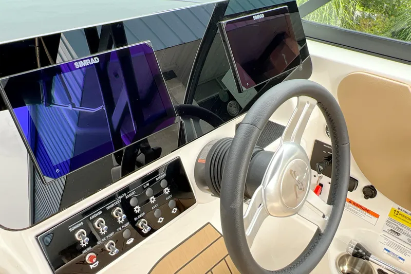 Slide: The Image of 2026 Sea Ray SDX 230 dashboard with dual Simrad displays and steering wheel. - 10
