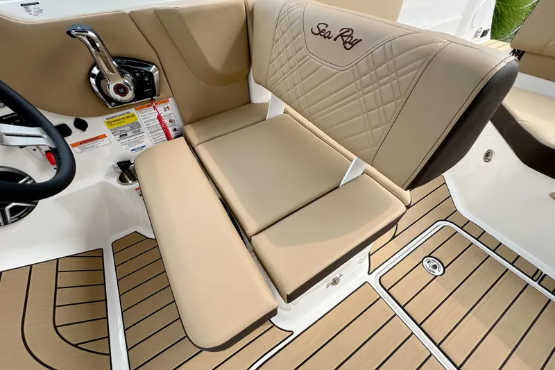 Slide: The Image of 2026 Sea Ray SDX 230 boat interior with beige seating and modern controls. - 14