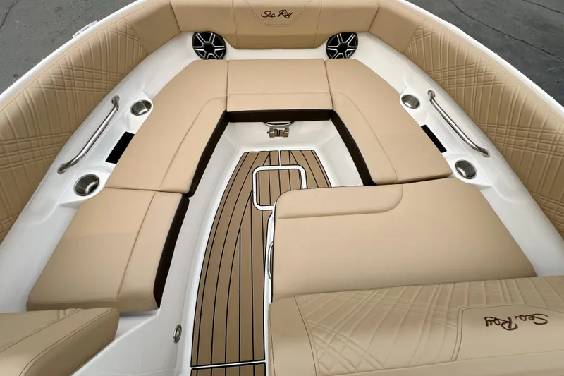 Slide: The Image of 2026 Sea Ray SDX 230 boat interior with tan seating and wood accents. - 15
