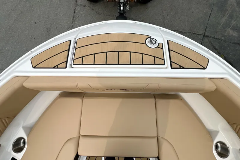 Slide: The Image of 2026 Sea Ray SDX 230 boat interior with beige seating and stylish deck design. - 17