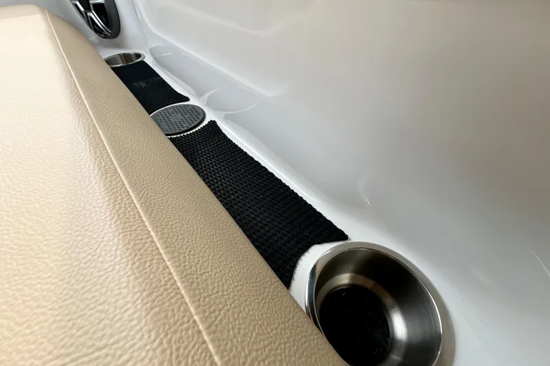 Slide: The Image of 2026 Sea Ray SDX 230 interior with cup holders and beige seating. - 19