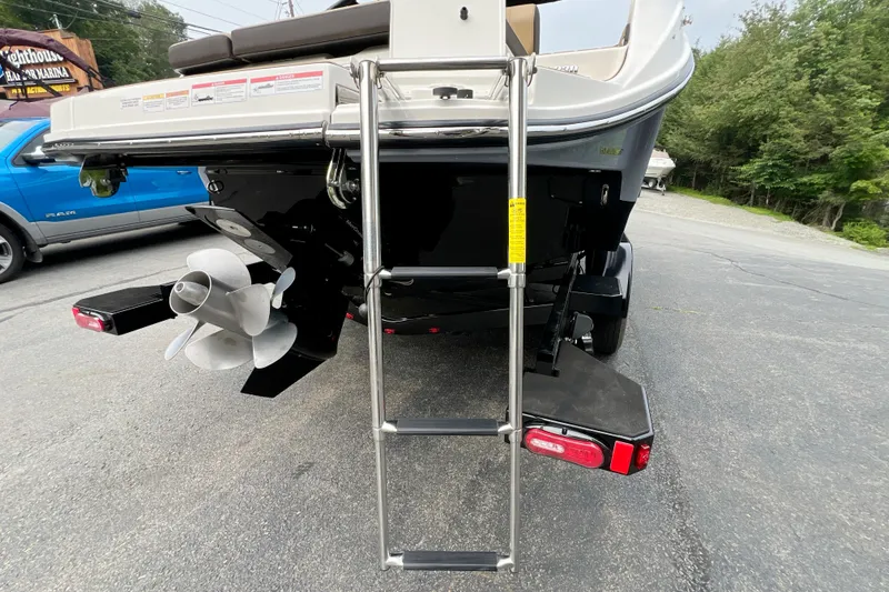 Slide: The Image of Rear view of 2026 Sea Ray SDX 230 boat with ladder and propeller. - 2