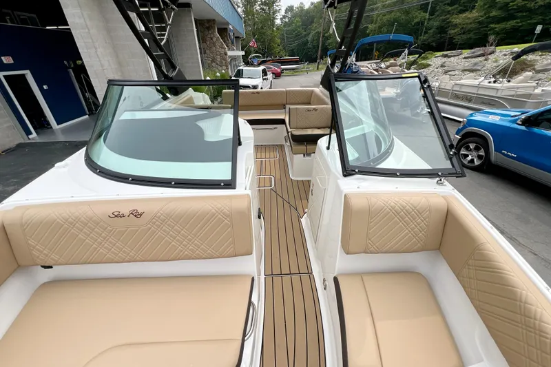 Slide: The Image of 2026 Sea Ray SDX 230 boat interior with tan seating and sleek design. - 20