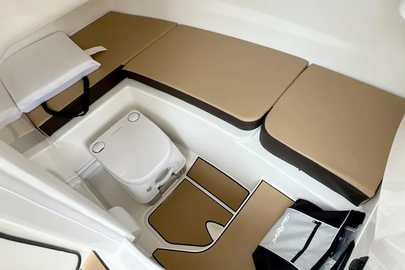 Slide: The Image of Interior of 2026 Sea Ray SDX 230 boat with seating and portable toilet. - 5