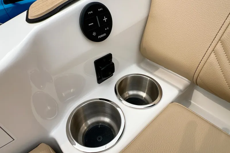 Slide: The Image of 2026 Sea Ray SDX 230 boat interior with cup holders and audio controls. - 6
