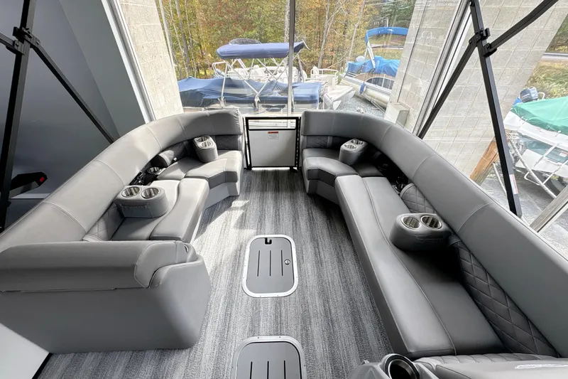Slide: The Image of Luxurious interior of 2026 Bennington 24 LSB pontoon boat with plush seating and cup holders. - 10
