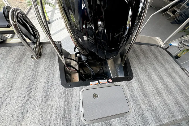 Slide: The Image of 2026 Bennington 24 LSB boat deck with sleek black motor and gray flooring. - 11