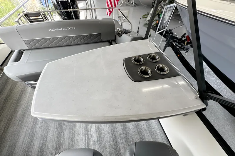 Slide: The Image of 2026 Bennington 24 LSB boat interior with sleek seating and modern table design. - 19
