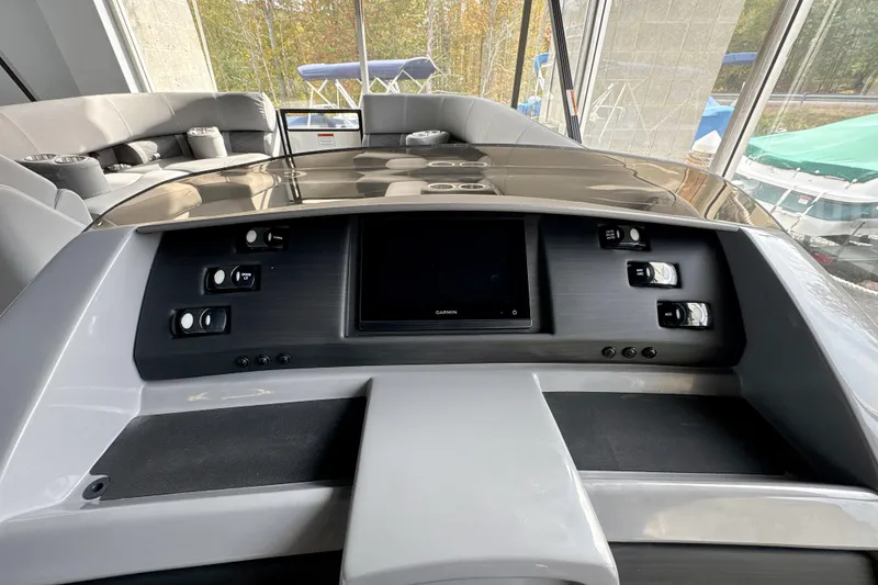 Slide: The Image of 2026 Bennington 24 LSB boat dashboard with modern controls and touchscreen display. - 4