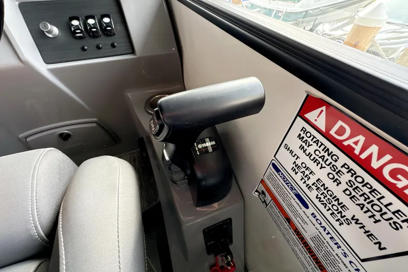 Slide: The Image of Control panel and throttle of 2026 Bennington 24 LSB boat with safety warning label. - 5