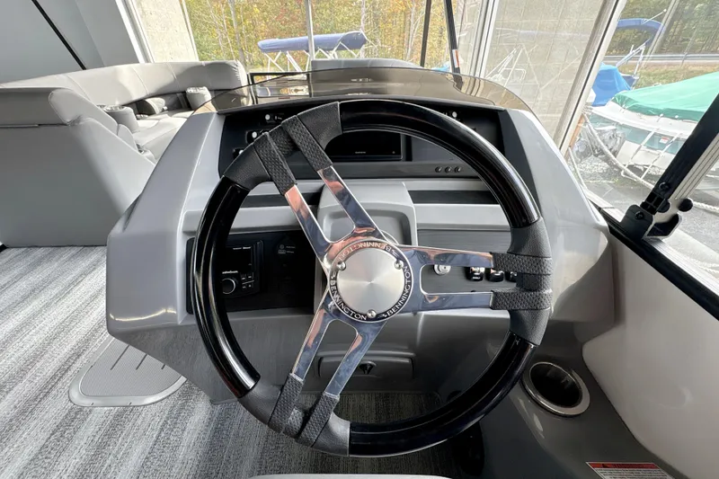 Slide: The Image of Steering wheel of a 2026 Bennington 24 LSB boat, featuring modern design and controls. - 6