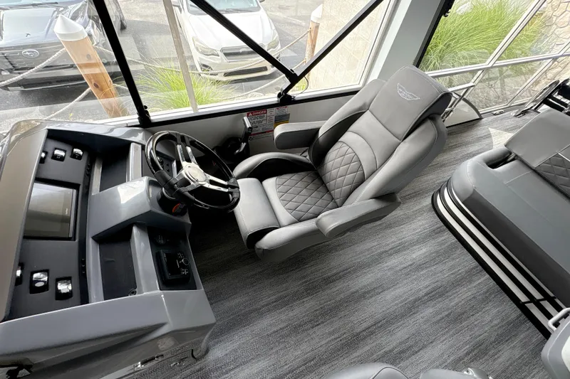 Slide: The Image of 2026 Bennington 24 LSB boat interior with luxurious seating and modern dashboard. - 9