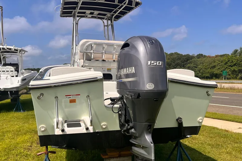 Slide: The Image of 2016 Parker 2100 Special Edition boat with Yamaha 150 engine, displayed outdoors. - 2