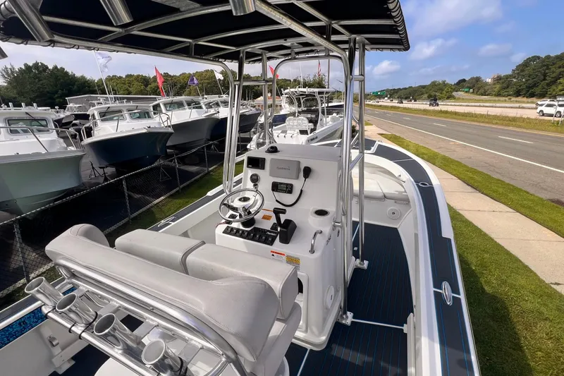 Slide: The Image of 2016 Parker 2100 Special Edition boat with sleek design, docked near a road. - 3