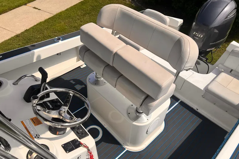 Slide: The Image of 2016 Parker 2100 Special Edition boat interior with steering wheel and seating. - 5