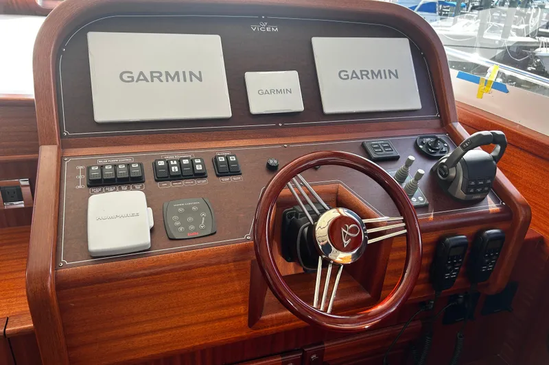 Slide: The Image of 2026 Vicem 55 Classic yacht helm with Garmin navigation and wooden steering wheel. - 4