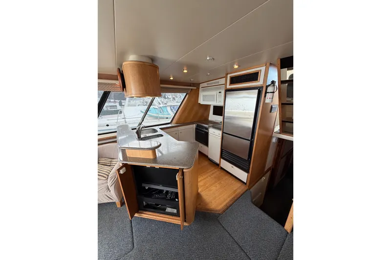 Slide: The Image of Interior of 1998 Bayliner 4788 Pilot House Motoryacht with modern kitchen amenities. - 15