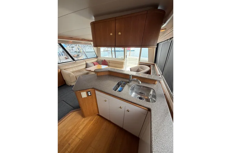Slide: The Image of Interior of 1998 Bayliner 4788 Pilot House Motoryacht with kitchen and seating area. - 19