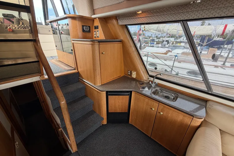 Slide: The Image of Interior of 1998 Bayliner 4788 Pilot House Motoryacht with kitchenette and stairs. - 21