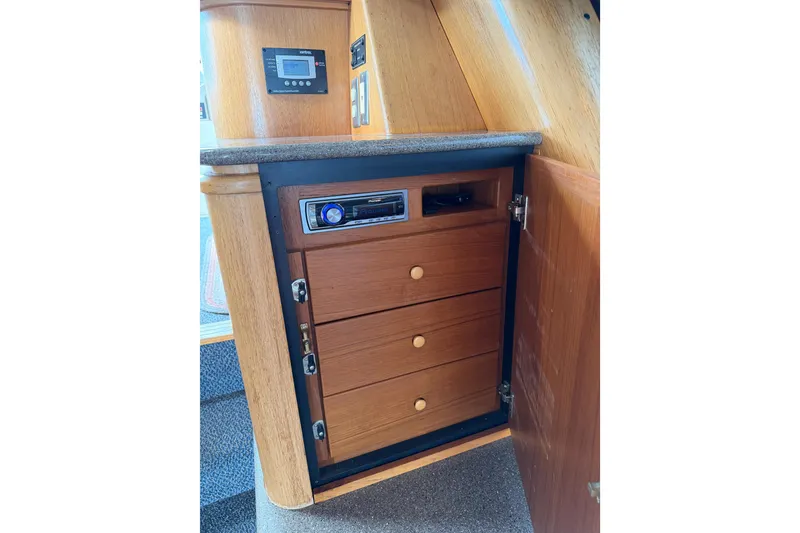 Slide: The Image of 1998 Bayliner 4788 Pilot House Motoryacht interior with wooden cabinet and stereo system. - 23