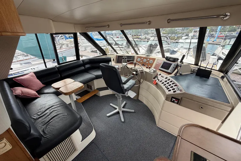 Slide: The Image of 1998 Bayliner 4788 Pilot House Motoryacht interior with helm, seating, and navigation equipment. - 26