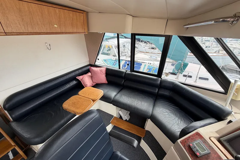 Slide: The Image of Luxurious interior of 1998 Bayliner 4788 Pilot House Motoryacht with leather seating and wood accents. - 27