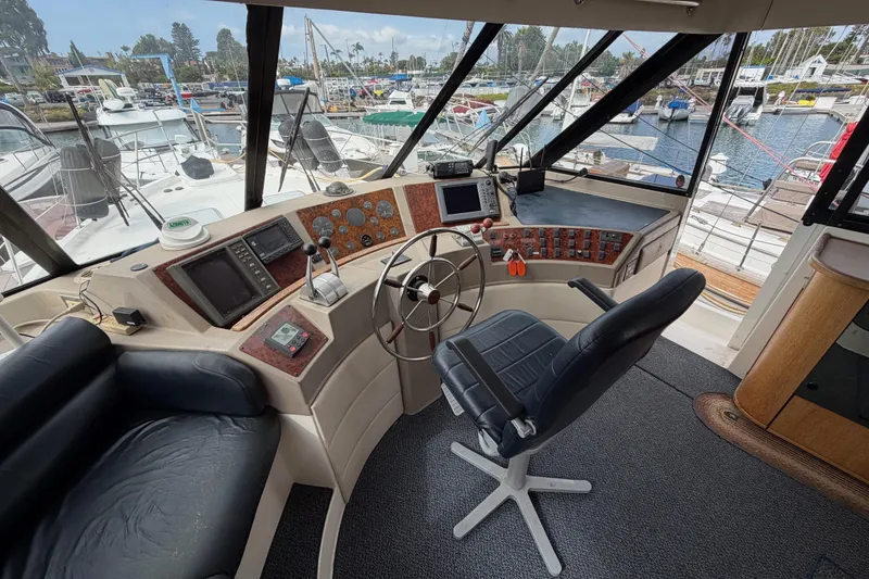 Slide: The Image of Interior of 1998 Bayliner 4788 Pilot House Motoryacht with helm and marina view. - 28