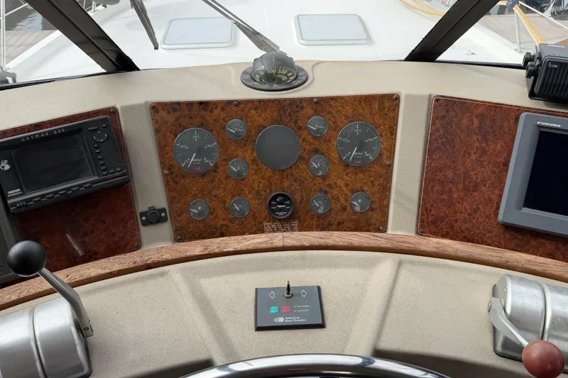 Slide: The Image of 1998 Bayliner 4788 Pilot House Motoryacht dashboard with gauges and navigation equipment. - 31