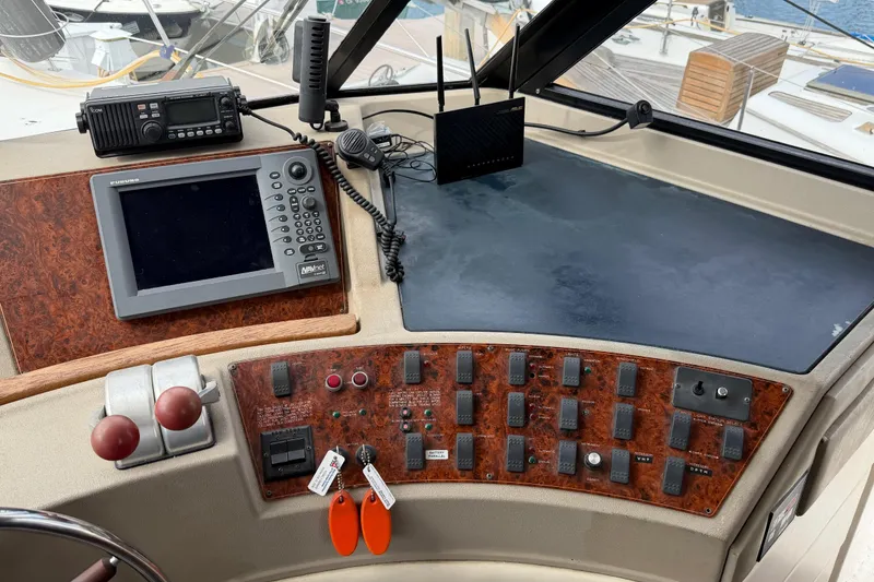 Slide: The Image of 1998 Bayliner 4788 Pilot House Motoryacht helm with navigation and control panels. - 32