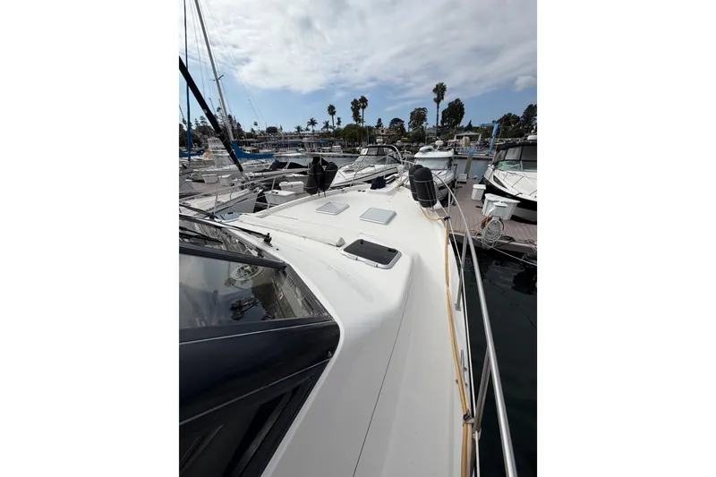 Slide: The Image of 1998 Bayliner 4788 Pilot House Motoryacht docked at marina under cloudy sky. - 35