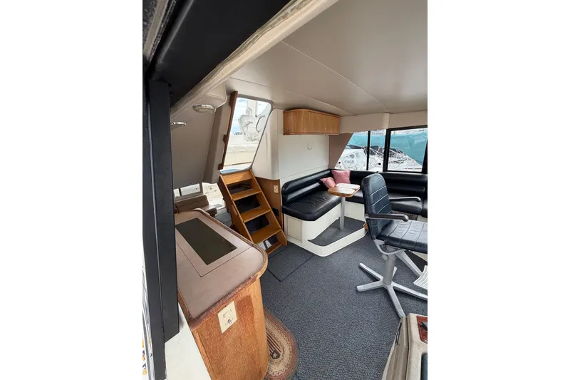 Slide: The Image of 1998 Bayliner 4788 Pilot House Motoryacht interior with seating, table, and stairs. - 38