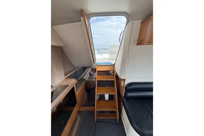 Slide: The Image of Interior view of 1998 Bayliner 4788 Pilot House Motoryacht with wooden stairs and seating. - 39