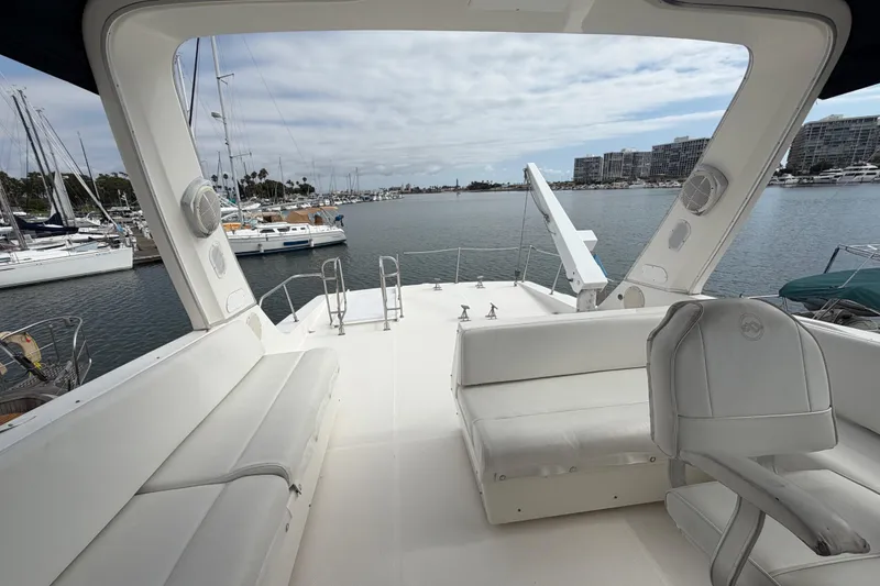 Slide: The Image of 1998 Bayliner 4788 Pilot House Motoryacht deck with seating, overlooking marina and waterfront buildings. - 40
