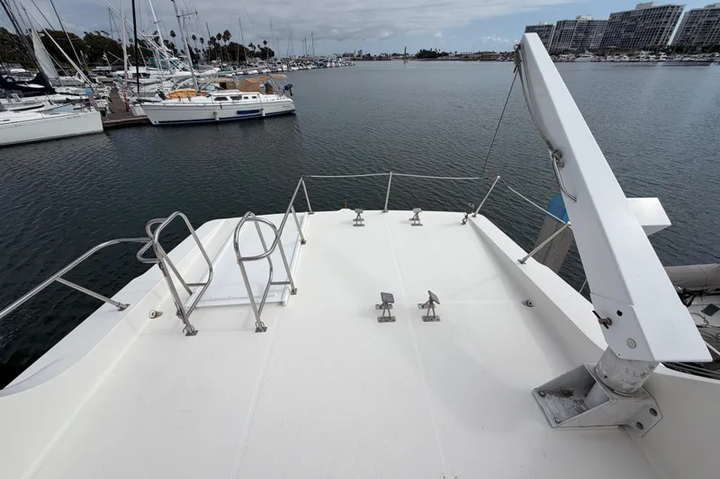 Slide: The Image of 1998 Bayliner 4788 Pilot House Motoryacht deck overlooking marina with sailboats. - 41